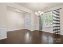 Open-concept living area boasts dark hardwood floors, white wainscoting, and natural lighting at 1020 Bannister Rd, Waxhaw, NC 28173