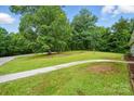 Expansive front yard with lush green grass and mature trees at 1038 Blake Rd, Albemarle, NC 28001