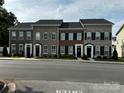 Charming townhomes featuring brick exteriors, black shutters, and well-maintained landscaping at 110 W Pine St, Lincolnton, NC 28092