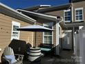 Cozy outdoor patio with comfortable seating, umbrella, and stylish barrel table at 110 W Pine St, Lincolnton, NC 28092