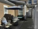 Cozy outdoor patio with comfortable seating, umbrella, and stylish barrel table at 110 W Pine St, Lincolnton, NC 28092
