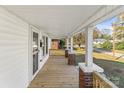 Inviting front porch with wood flooring and brick and white support columns provides a charming entrance at 1102 Venus St, Kannapolis, NC 28083