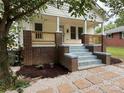 Inviting home exterior featuring a classic front porch with brick accents and newly installed landscaping at 1102 Venus St, Kannapolis, NC 28083