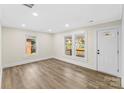 Bright living room featuring wood floors, white trim, and natural light from updated windows at 1102 Venus St, Kannapolis, NC 28083