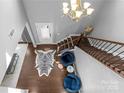 Elegant two-story foyer featuring hardwood floors, staircase, and decorative touches for a grand entrance at 11209 Flenniken Ct, Charlotte, NC 28277