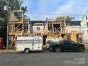 New construction townhomes are in progress with wood framing, ready for customization and modern finishes at 113 Verbena Ne St # 11, Charlotte, NC 28217