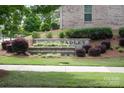 Landscaped community sign with decorative brick and colorful flowerbeds at 1142 Doveridge St, Charlotte, NC 28273