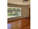 Bright living room with hardwood floors and large windows offering a pleasant view at 1412 Beverly Ave, Shelby, NC 28152