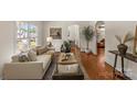 Open-concept living room with hardwood floors, stylish decor, and a cozy seating area at 1500 Lynway Dr, Charlotte, NC 28203