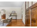 Bright living room with hardwood floors, a console table, and an open doorway at 1500 Lynway Dr, Charlotte, NC 28203