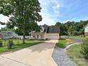 Inviting home with a spacious driveway, attached garage, and a well-manicured lawn and garden at 1505 Wimbleton Woods Dr # 5, Fort Mill, SC 29708