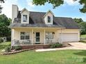 Charming home with a welcoming front porch, attached garage, and well-maintained lawn and landscaping at 1505 Wimbleton Woods Dr # 5, Fort Mill, SC 29708