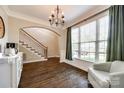 Bright dining room featuring hardwood floors, large window, and elegant chandelier at 1648 Jonesberry Dr, Rock Hill, SC 29732