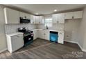 Modern kitchen with white cabinets, stainless steel appliances, subway tile backsplash, and stylish blue dishwasher at 1735 Hollandale Dr, Gastonia, NC 28054