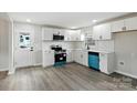 Updated kitchen featuring white cabinets, modern appliances, and a stylish backsplash at 1735 Hollandale Dr, Gastonia, NC 28054