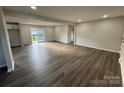 Spacious living room featuring new flooring, neutral walls, recessed lighting, and sliding glass door at 1735 Hollandale Dr, Gastonia, NC 28054