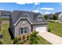 Beautiful home with stone accents, manicured shrubs, and a two car garage at 19004 Dry Narrows Way, Charlotte, NC 28278