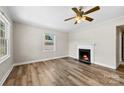 Bright living room featuring luxury vinyl floors, a ceiling fan, and fireplace at 2009 Auten Rd, Gastonia, NC 28054