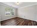 Bright bedroom with hardwood floors, trim, and a large window providing natural light at 2028 Covered Bridge Ct, Rock Hill, SC 29732