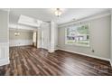 Spacious living room featuring hardwood floors, a large window, and elegant trim work at 2028 Covered Bridge Ct, Rock Hill, SC 29732