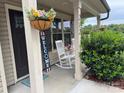 Cozy front porch featuring rocking chairs, hanging flowers, and welcoming decor at 212 Old Centergrove Rd, Kannapolis, NC 28083