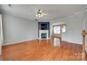 Spacious living room featuring hardwood floors, a fireplace, and an open layout to the dining area at 228 Dawn Mist Ln, Fort Mill, SC 29708