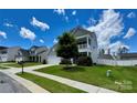 Lovely home with a well-kept lawn, mature tree, and classic architectural details at 2311 Verde Creek Rd, Charlotte, NC 28214