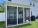 Screened porch featuring outdoor seating, a ceiling fan, and a grill at 2311 Verde Creek Rd, Charlotte, NC 28214