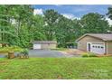 Detached garage and carport with a concrete driveway, surrounded by a grassy yard at 3017 Brooks Mill Ln # 10, Wingate, NC 28174