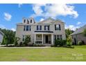 Charming two-story home with a covered porch, dormer windows, and a well-manicured lawn at 319 S San Agustin Dr, Mooresville, NC 28117