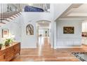 Welcoming foyer with hardwood floors, staircase, and views into the dining and living areas at 319 S San Agustin Dr, Mooresville, NC 28117