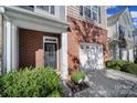 Inviting front entrance featuring a brick facade, a black front door, and a convenient one-car garage at 3342 Yarmouth Ln, Gastonia, NC 28056