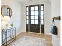 Bright foyer with hardwood floors, stylish rug, and decorative accents at 3924 Dahlia Dr, Harrisburg, NC 28075