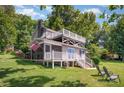 Charming lake house features a covered porch, upper deck, and lush green lawn at 4586 Doctor Dr, Catawba, NC 28609