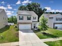 Two-story home with a driveway, 2-car garage, and green lawn at 461 Misty Law Ln, Clover, SC 29710