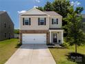 Charming two-story house with neutral siding, dark shutters, and a manicured lawn and landscaping at 461 Misty Law Ln, Clover, SC 29710