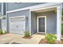 Exterior of home featuring a one-car garage, gray siding, and neatly trimmed bushes at 502 Tayberry Ln, Fort Mill, SC 29715