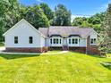 Charming single-Gathering home with brick accents and lush green lawn at 511 Brookwood Dr, Statesville, NC 28677