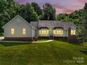Charming single Gathering home features a landscaped lawn, brick accents, and large windows that bring in natural light at 511 Brookwood Dr, Statesville, NC 28677