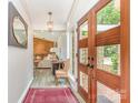 Foyer with wood-look floors and a view of the living room through wood and glass double doors at 5114 Leisure Ln, Sherrills Ford, NC 28673