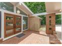 Home features brick pavers, double doors with geometric details, and decorative breeze blocks at 5114 Leisure Ln, Sherrills Ford, NC 28673