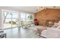 Living room features a brick fireplace, lake views, and neutral walls at 5114 Leisure Ln, Sherrills Ford, NC 28673
