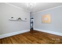 Elegant living room featuring gleaming hardwood floors, a decorative shelf, and a stylish chandelier at 524 Hawthorne Ln, Charlotte, NC 28204