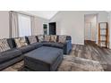 Comfortable living room area with stylish sectional sofa, ottoman and wood-look floors at 532 Jedburgh Way, Rock Hill, SC 29730