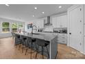 Spacious kitchen with white cabinets, a large island, and stainless steel appliances at 6032 Corbin Woods Ct, Charlotte, NC 28226