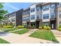 Attractive townhome exteriors with brick and siding, complemented by vibrant landscaping and well-maintained lawns at 628 Uwharrie River Rd, Charlotte, NC 28211
