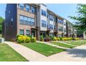 Charming street view of modern townhomes with well-kept lawns and landscaped front yards on a sunny day at 628 Uwharrie River Rd, Charlotte, NC 28211