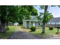Cozy green house with a small front porch and a tree-lined yard at 639 S Eastway Dr, Troutman, NC 28166