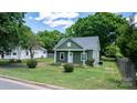 Quaint green home with a welcoming porch and a lush front yard at 639 S Eastway Dr, Troutman, NC 28166