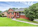 Attractive red brick house with a sidewalk leading to the front entrance at 6908 Lancer Dr, Charlotte, NC 28226